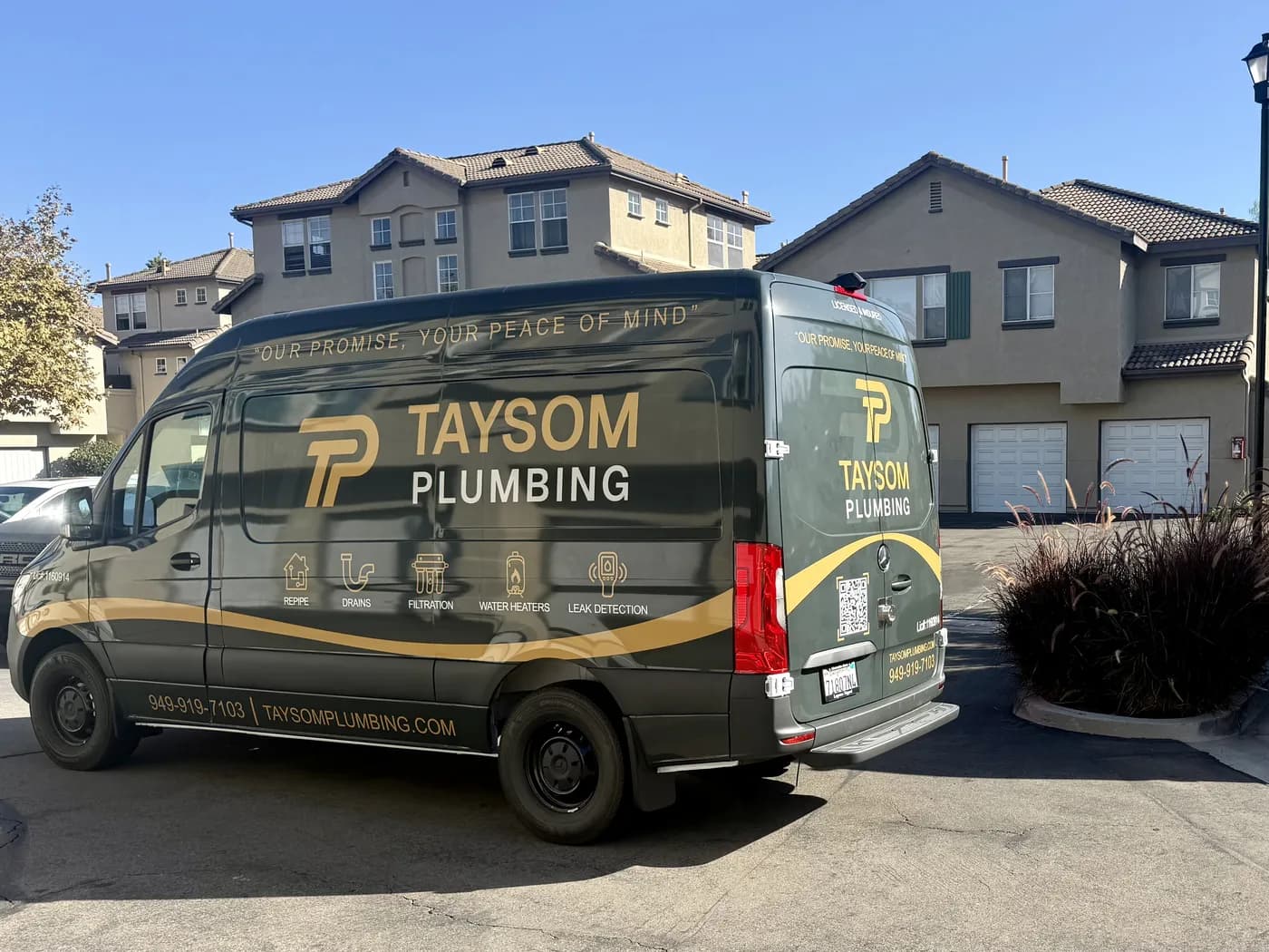 A Taysom Plumbing van parked outside a customer’s home